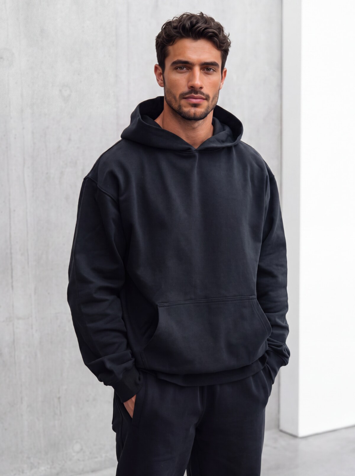 Cyrus wearing the black Cyrus Boyfriend Hoodie in a studio